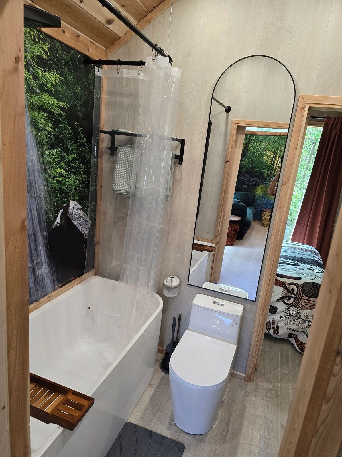 Bathroom with soaking tub and waterfall mural at Cabin @28