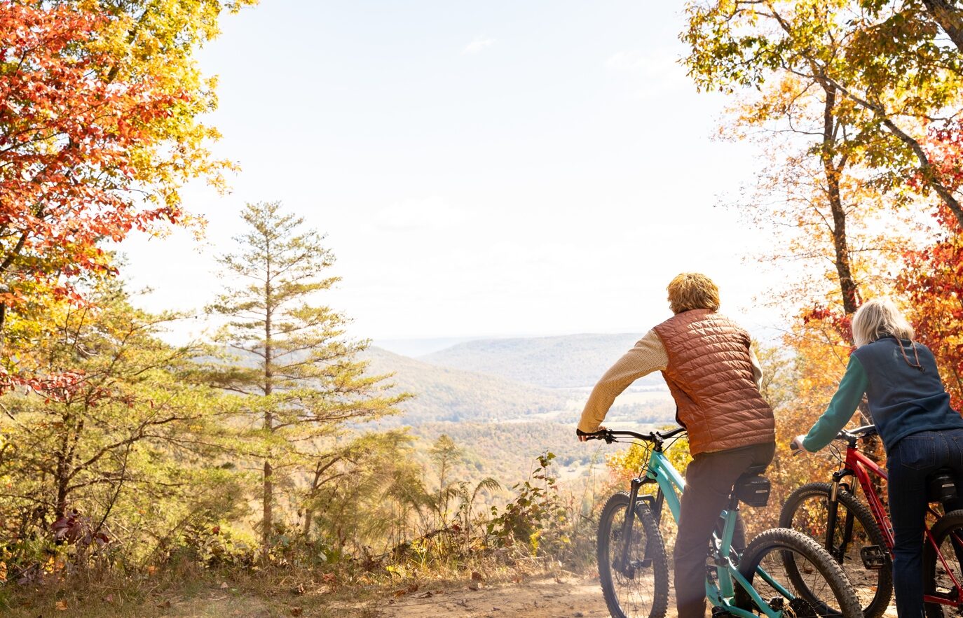 Mountain bikers pausing at a valley overlook on the trails at Sasquatch Farm RV Park