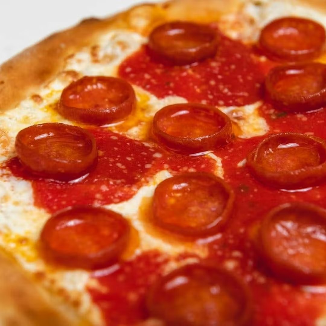 Close-up of a coal fired pepperoni pizza fresh from the oven