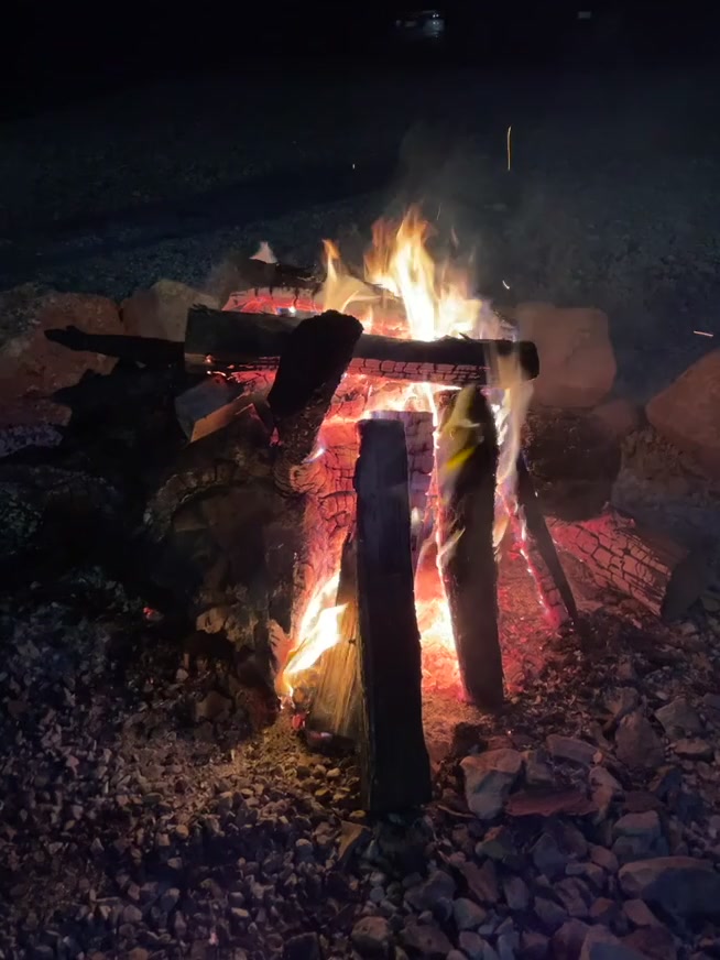 Outdoor fire pit glowing at night at the Spa King Cabin