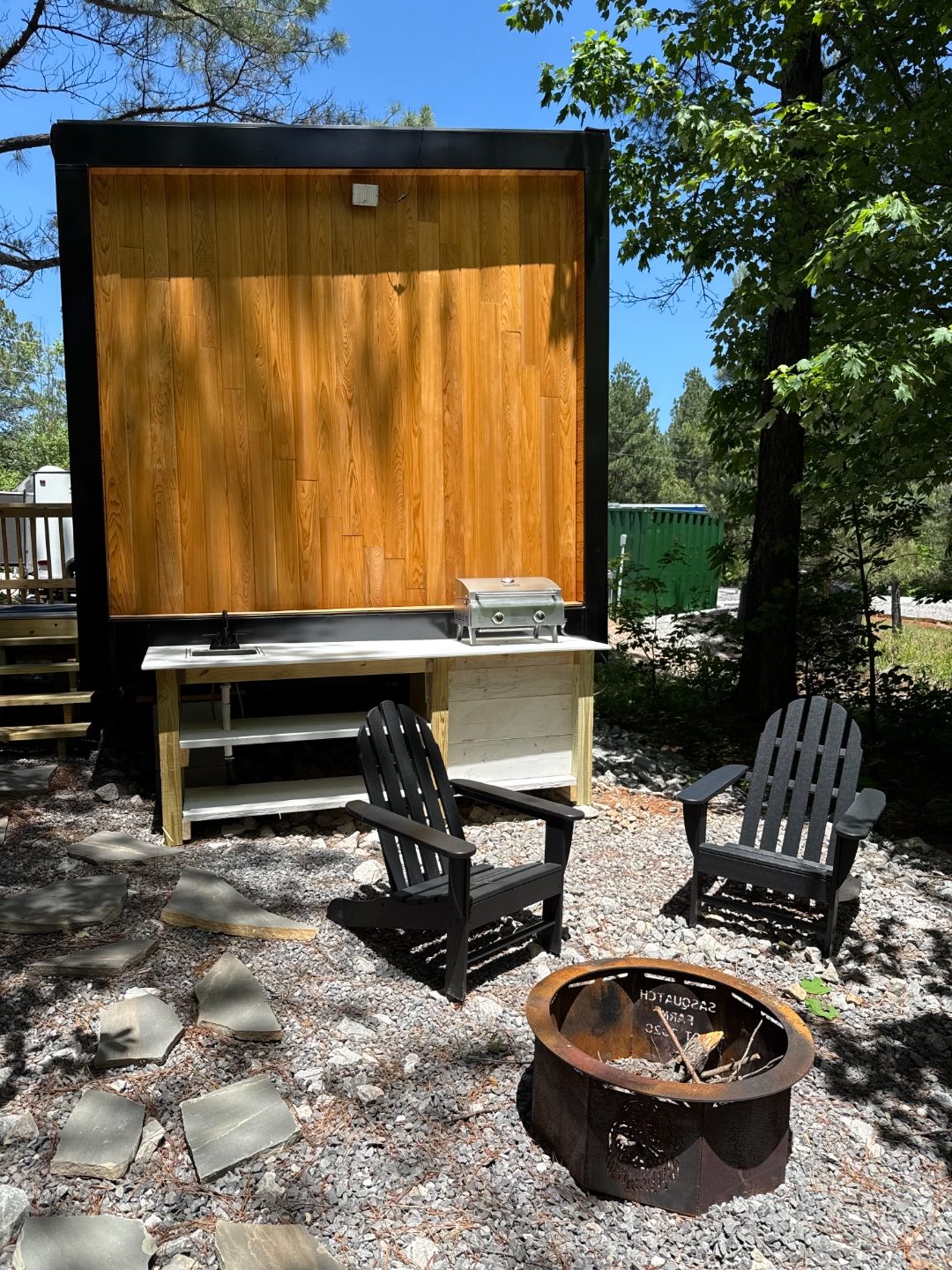 Outdoor kitchenette, grill, and fire pit at the Spa King Cabin
